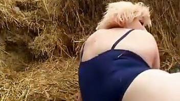 Twisted blonde fucks a dog in the hay
